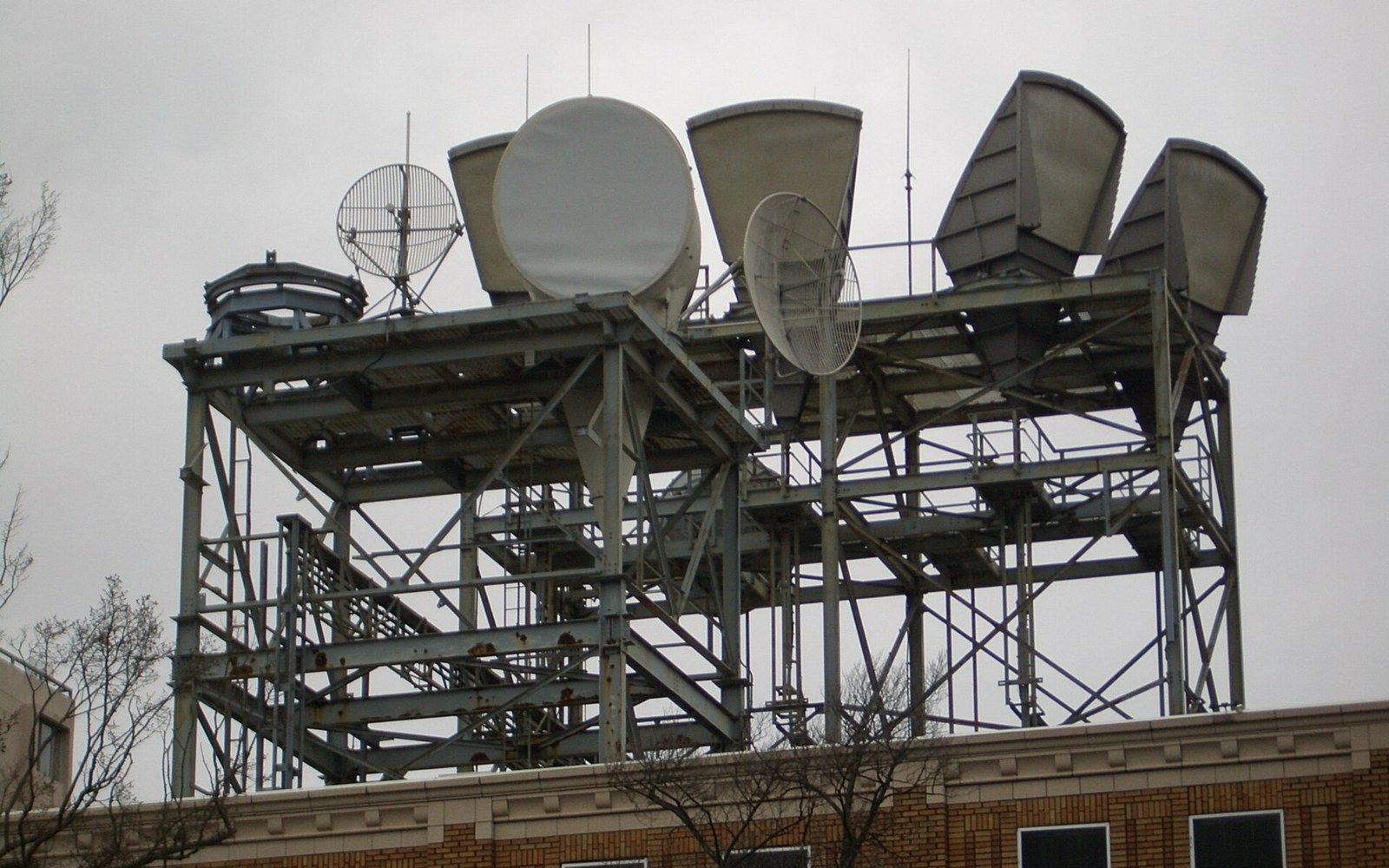 Rooftop steel tower holding multiple microwave dish and horn antennas